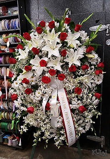 White Standing Spray Accented with Red Roses